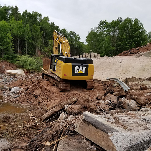 Excavator digging among rubble