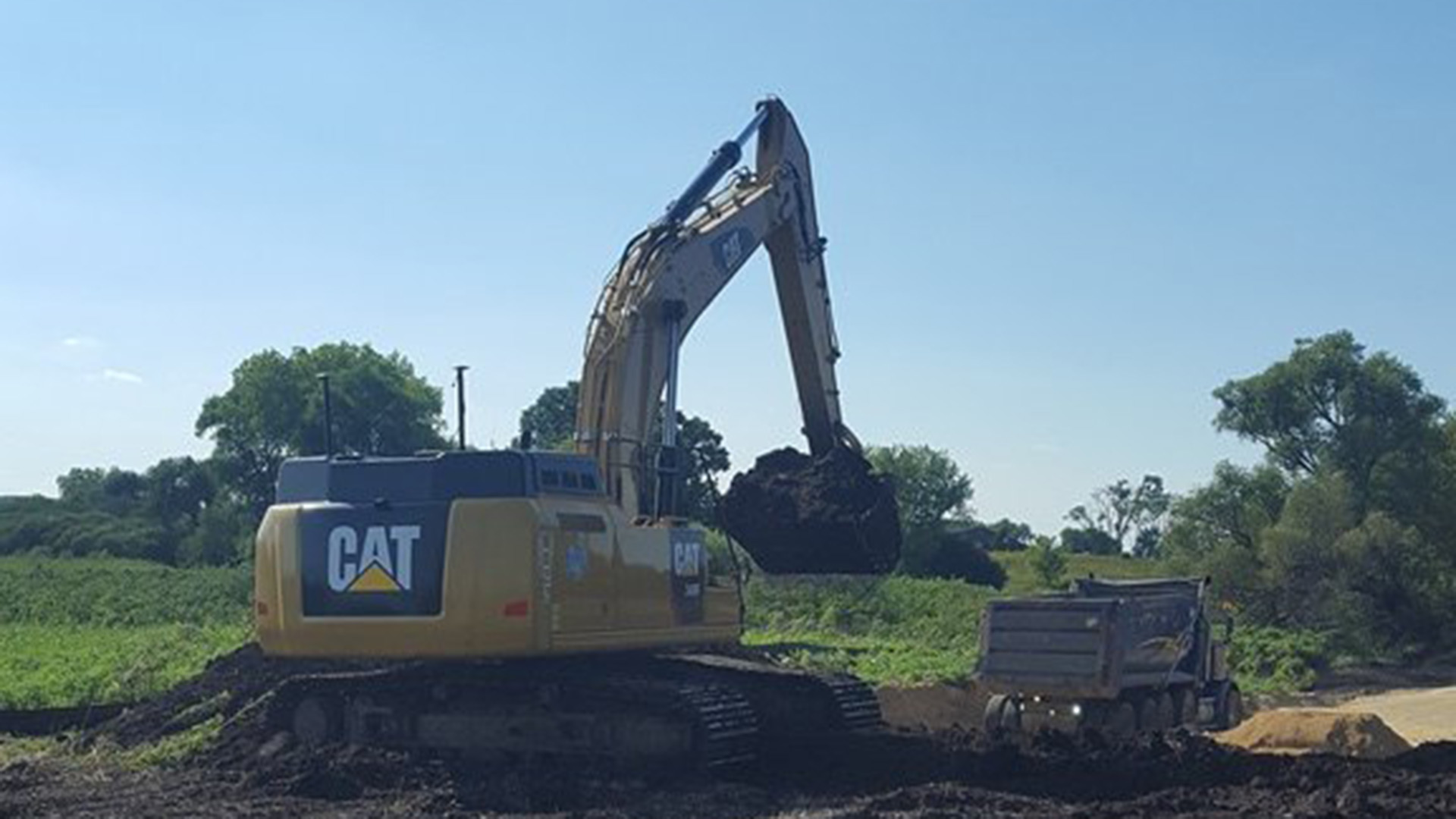 Excavator moving dirt