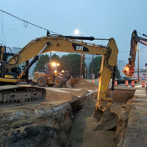 Excavator digging in a road